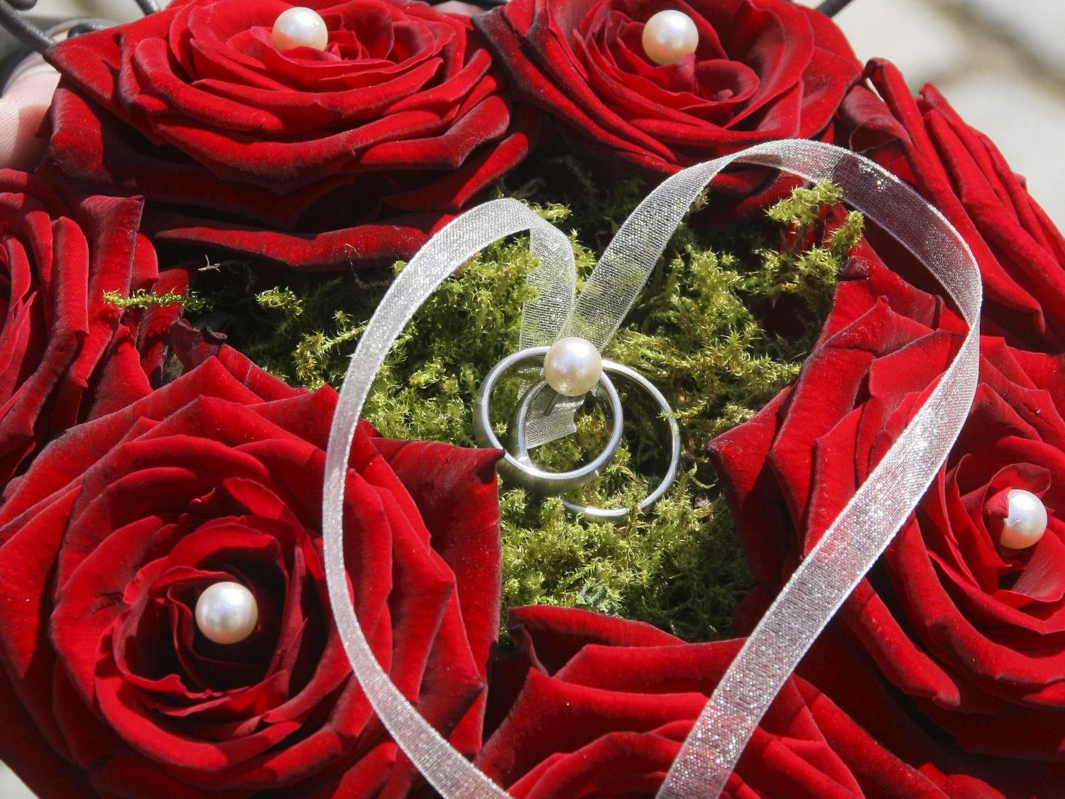 ein herz aus rosen mit zwei ringe in der mitte
